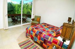 2nd bedroom with private bath & balcony and garden view.